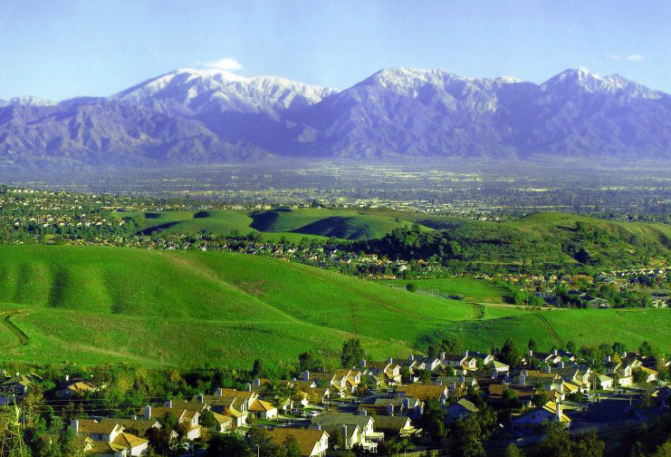 The Chino Hills and skyline of Chino Hills with the Pomona Valley beyond and the San Gabriel Mountains rising in the background.
