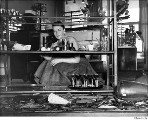 Margaret Gaines began to tidy up the debris of broken glassware at a Stonestown shop following the earthquake in March 1957. Photo courtesy San Francisco Chronicle.